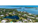 Waterfront estate with an amazing water view, lush landscaping, and a serene pond nearby at 112 Osprey Point Dr, Osprey, FL 34229