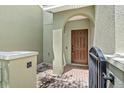 Close-up of the private courtyard entry featuring brick pavers and a black metal gate at 2943 Willowleaf Ln, Wesley Chapel, FL 33544