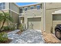 A great townhouse featuring a courtyard, one car garage, and low maintenance landscaping at 2943 Willowleaf Ln, Wesley Chapel, FL 33544