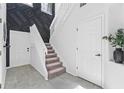 Bright foyer featuring tile floors, staircase and accent wall at 2943 Willowleaf Ln, Wesley Chapel, FL 33544