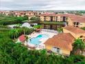 Overhead view of the community pool area, nestled among trees and residential buildings at 4333 Bayside Village Dr # 310, Tampa, FL 33615