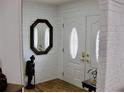 Foyer with an ornate mirror and a double door with stained glass, and a decorative statue at 7026 Lenape Cir, New Port Richey, FL 34653
