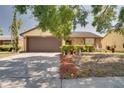 A cozy single-Gathering home featuring a well-manicured front lawn, decorative shrubbery and a convenient two-car garage at 7418 Riverbank Dr, New Port Richey, FL 34655