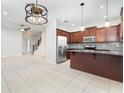 Open kitchen featuring stainless appliances, tile floors, granite counters and a large island at 12232 Trailhead Dr, Bradenton, FL 34211