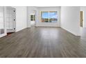 An empty living room featuring new, modern vinyl flooring and a beautiful view out the window at 5154 51St W Ln, Bradenton, FL 34210