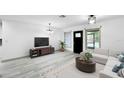 Bright living room features lots of natural light, modern furniture, and sleek flooring at 7490 Locust Ne St, St Petersburg, FL 33702