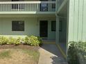 Exterior view of a building with a front door and manicured landscaping at 129 Caryl Way # 129, Oldsmar, FL 34677