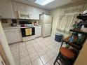 Functional kitchen with white cabinets, a microwave, and tile flooring at 129 Caryl Way # 129, Oldsmar, FL 34677