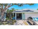 Exterior of home showing covered entrance to the property and access to the attached garage at 1369 Brookside Dr, Venice, FL 34285