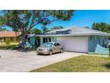 Inviting single-story home with a spacious driveway, attached garage, and a well-manicured lawn at 1369 Brookside Dr, Venice, FL 34285