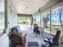 View of the covered and screened front porch, showcasing the outdoor seating area at 1369 Brookside Dr, Venice, FL 34285