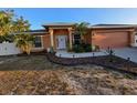 Charming single-story home with a well-maintained lawn and an attached two-car garage at 22227 Elmira Blvd, Port Charlotte, FL 33952