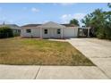 Charming single-story home features a quaint front porch, attached garage, and driveway at 38832 Henry Dr, Zephyrhills, FL 33542