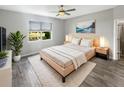 Cozy bedroom with a plush rug, serene decor, and a large window overlooking a scenic view at 19664 Ship Wheel Way, Land O Lakes, FL 34638