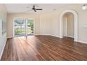 Bright living room with hardwood floors, neutral walls, and plenty of natural light at 3319 Thistledown Ln, Land O Lakes, FL 34638