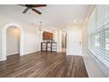 Open-concept living area with hardwood floors, arched doorways, and easy access to the kitchen at 3319 Thistledown Ln, Land O Lakes, FL 34638
