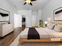 Airy main bedroom featuring hardwood floors, closet, an ensuite bathroom, and a ceiling fan at 6370 Sturbridge Ct, Sarasota, FL 34238