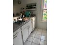 Kitchen featuring ample counter space, a stainless steel sink, and white cabinets at 3585 41St S Way # D, St Petersburg, FL 33711