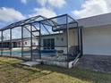 Backyard features a screened lanai over a large pool, seamlessly blending indoor and outdoor living at 4299 Bullard St, North Port, FL 34287