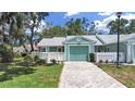 Inviting single-story home with a manicured lawn, fenced yard, and attached one-car garage at 12519 Knollbrook Ln, Hudson, FL 34669