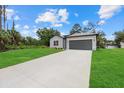 Beautiful single-story home with a long driveway leading to an attached two-car garage at 2945 Cascabel Ter, North Port, FL 34286