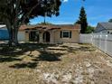 Charming single-story home with a quaint front porch and manicured landscaping at 13122 Cumberland Dr, Largo, FL 33773