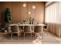 Stylish dining room with a modern table, six chairs, wood accents, and ample natural light at 16491 Hillsborough Blvd, Port Charlotte, FL 33954