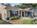 Beautiful home boasts a well-maintained lawn, complemented by vibrant landscaping and inviting curb appeal at 1904 Crown Park Dr, Valrico, FL 33594