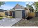 This inviting home features a charming facade, complemented by a one car garage and a well-manicured lawn at 1904 Crown Park Dr, Valrico, FL 33594