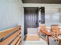 Inviting front porch with wooden chairs and a stylish black front door, perfect for relaxing at 2904 Sanchez St, Tampa, FL 33605