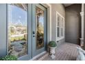 Inviting front entrance featuring an ornate glass door, brick flooring, and a decorative potted plant at 8721 Crystal Creek Ct, Land O Lakes, FL 34638
