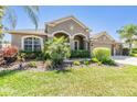 Beautiful one-story home featuring lush landscaping, vibrant green lawn, and a neutral color palette at 8721 Crystal Creek Ct, Land O Lakes, FL 34638