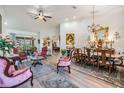 Elegant living room with vaulted ceilings, light wood floors, and an ornate dining set at 8721 Crystal Creek Ct, Land O Lakes, FL 34638