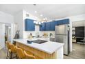 Bright kitchen with stylish blue cabinets, stainless steel appliances, and a breakfast bar with seating at 2356 Kingston S St, St Petersburg, FL 33711