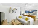 Cozy living room flows into a kitchen with a breakfast bar, featuring a comfortable sofa and bright decor at 2356 Kingston S St, St Petersburg, FL 33711
