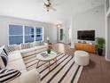Bright living room featuring stylish furniture and decor, with large windows offering plenty of natural light at 2936 Banyan Hill Ln, Land O Lakes, FL 34639