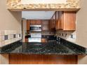 Kitchen with granite counters and tile backsplash at 738 Haven Pl, Tarpon Springs, FL 34689