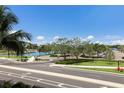 Scenic view featuring green spaces, walking paths, and a waterway under a bright blue sky at 1064 N Tamiami Trl # 1219, Sarasota, FL 34236
