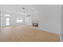 Bright living room with fireplace, wood floors and large windows for natural light at 709 Tuscanny St, Brandon, FL 33511