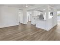 Bright open-concept living room with hardwood floors and a view of the modern kitchen at 3163 Key Ln, Port Charlotte, FL 33952