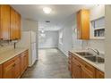 Eat-in kitchen featuring wood cabinets, stainless steel sink and white appliances at 408 Eunice Dr, Plant City, FL 33563