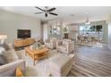 Bright, open-concept living area flowing into the dining and kitchen spaces with modern finishes and ample natural light at 18019 Avonsdale Cir, Port Charlotte, FL 33948