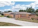 Aerial view of a one-story house with a two-car garage and an enclosed back porch at 1301 Lucaya Ave, Venice, FL 34285