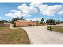 A long concrete driveway leads to a two-car garage, complemented by a well-kept yard at 1301 Lucaya Ave, Venice, FL 34285