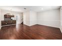 Open-concept living area featuring stylish hardwood floors and seamless flow to the kitchen at 14174 Oakham St, Tampa, FL 33626