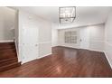 Spacious living room showcasing hardwood floors, a contemporary light fixture, and ample natural light at 14174 Oakham St, Tampa, FL 33626