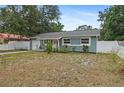 Charming single-story home with a blue exterior, well-maintained landscaping, and an attached garage at 2824 Oaklawn Ave, Largo, FL 33771