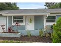 Inviting front entrance with a white door, manicured landscaping, and house number displayed at 2824 Oaklawn Ave, Largo, FL 33771
