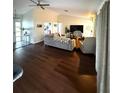Open-concept living room with plenty of natural light and hardwood floors at 3628 Nettle Creek Ct, Holiday, FL 34691