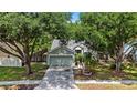 Inviting single Gathering home with a large driveway, mature trees, and a well-manicured lawn at 4605 Steel Dust Ln, Lutz, FL 33559
